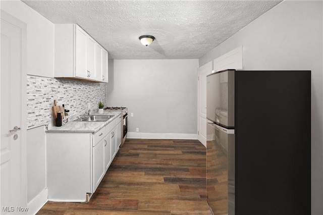 kitchen featuring stainless steel refrigerator, dark hardwood / wood-style floors, tasteful backsplash, and white cabinets