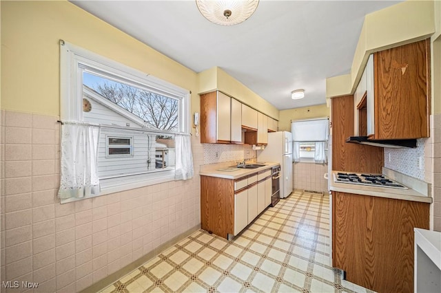 kitchen featuring tile walls and white appliances