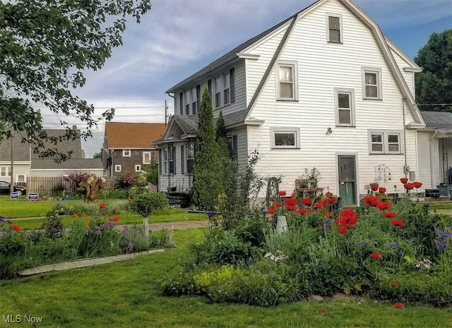 rear view of house featuring a lawn