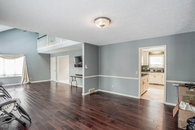 living room with plenty of natural light, sink, and hardwood / wood-style floors