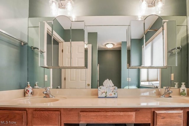 bathroom with a sink and double vanity