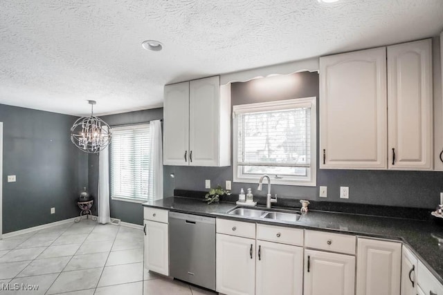 kitchen featuring sink, light tile patterned floors, dishwasher, pendant lighting, and white cabinets