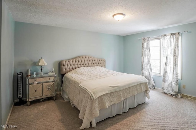 bedroom with carpet floors and a textured ceiling