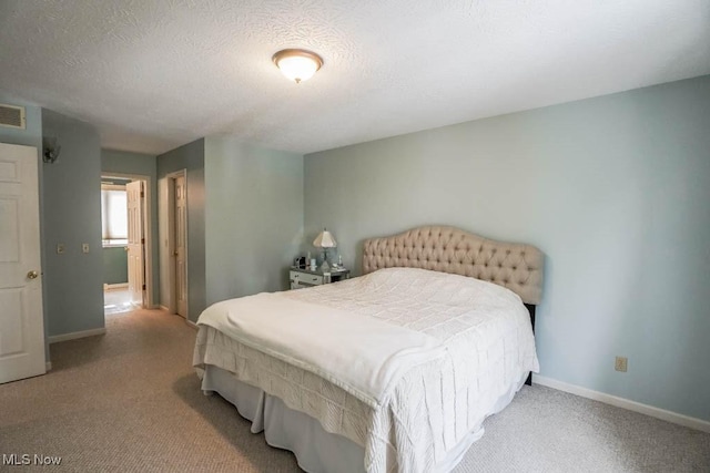 carpeted bedroom with a textured ceiling