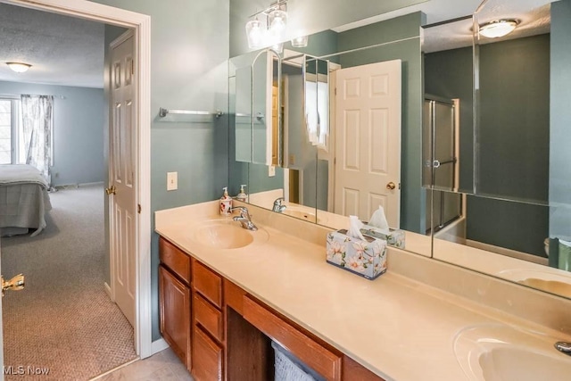 ensuite bathroom with a sink, a textured ceiling, ensuite bath, and double vanity