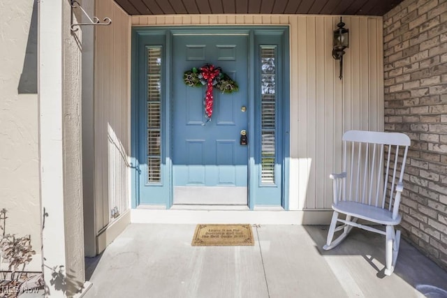 entrance to property featuring brick siding