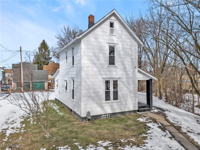 snow covered house with covered porch