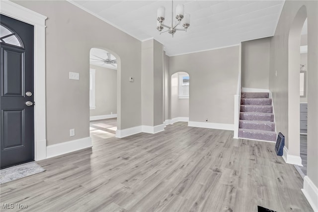 foyer featuring lofted ceiling, ceiling fan with notable chandelier, and light hardwood / wood-style floors