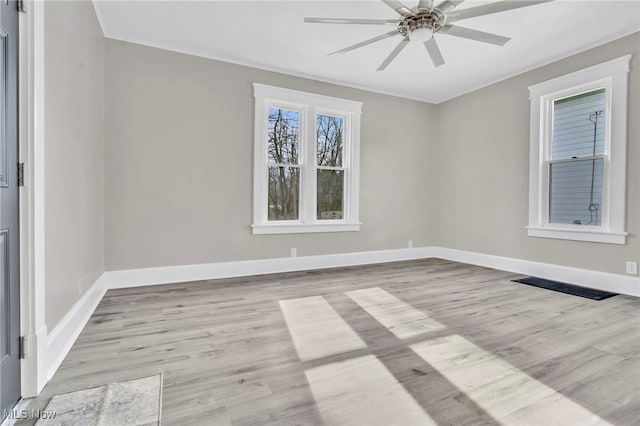 unfurnished room with ceiling fan, crown molding, and light hardwood / wood-style floors