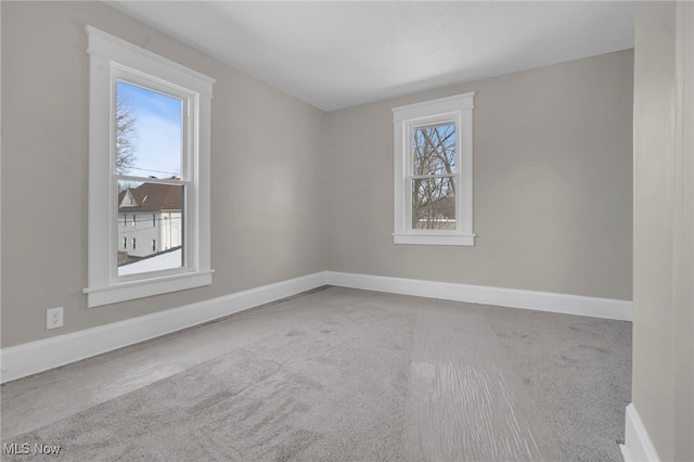 carpeted empty room with a wealth of natural light