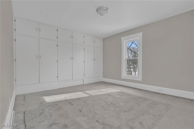 unfurnished bedroom featuring light colored carpet