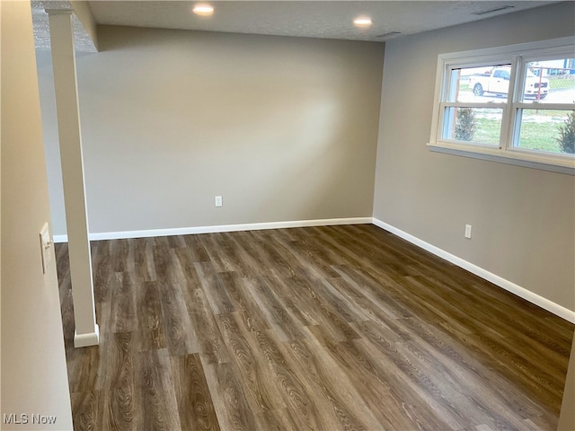 spare room with visible vents, recessed lighting, wood finished floors, and baseboards