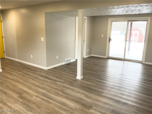 empty room with dark wood-type flooring