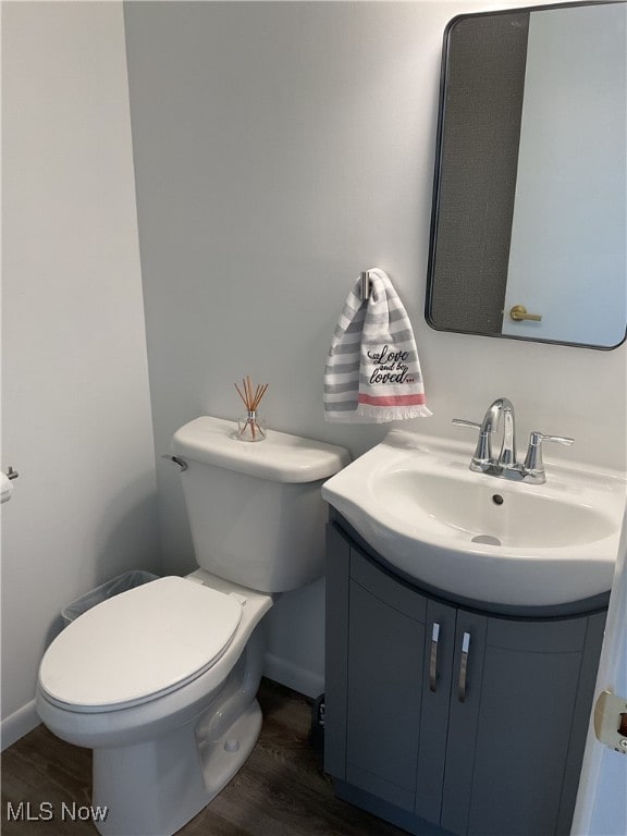 bathroom featuring vanity, toilet, and hardwood / wood-style floors