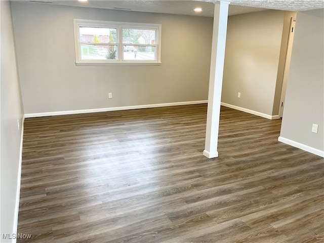 basement featuring dark hardwood / wood-style floors