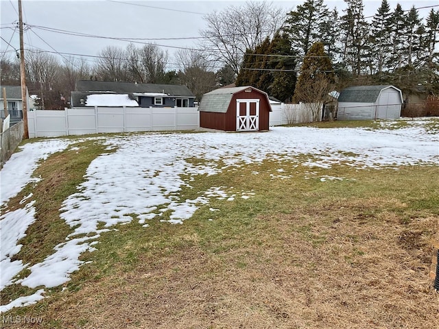 snowy yard with a storage unit