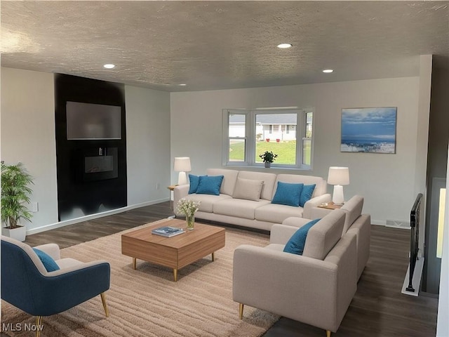 living area with recessed lighting, baseboards, a textured ceiling, and wood finished floors