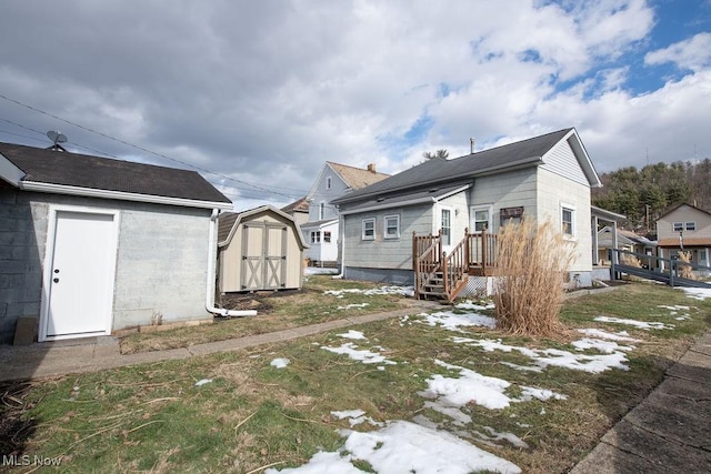 back of property featuring a storage unit