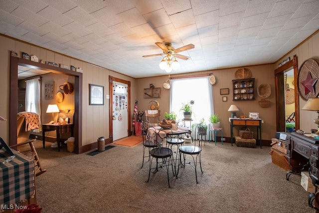 carpeted dining space featuring ceiling fan