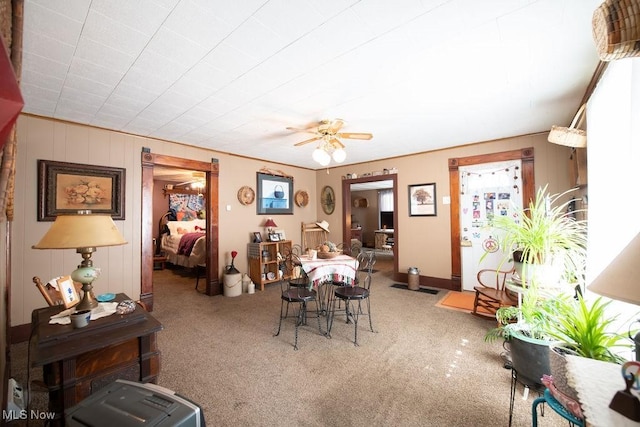 dining space with ceiling fan and carpet