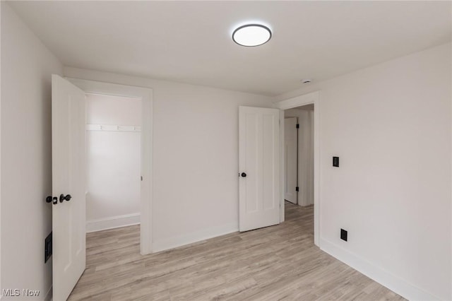 unfurnished room with light hardwood / wood-style flooring