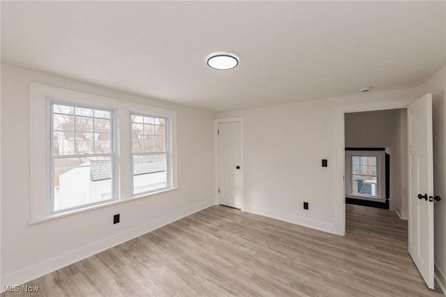 empty room with light hardwood / wood-style flooring