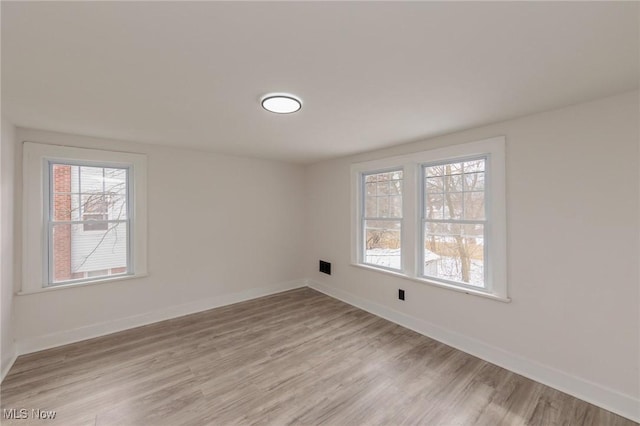 unfurnished room featuring light hardwood / wood-style floors