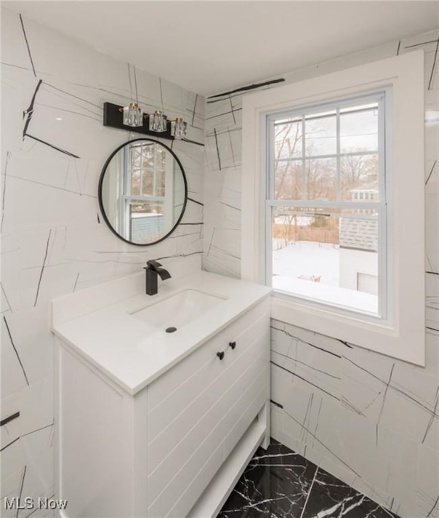 bathroom featuring vanity and tile walls