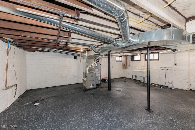 basement with water heater, sink, and heating unit