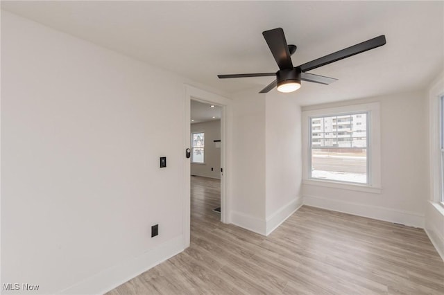 empty room with light hardwood / wood-style flooring and ceiling fan