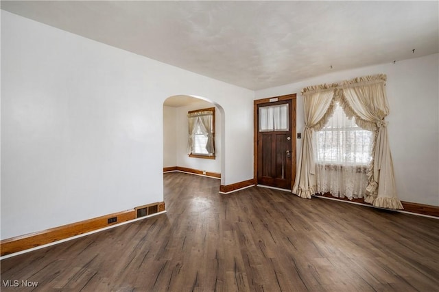 entrance foyer featuring a healthy amount of sunlight and dark hardwood / wood-style flooring