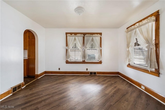 spare room featuring dark hardwood / wood-style flooring