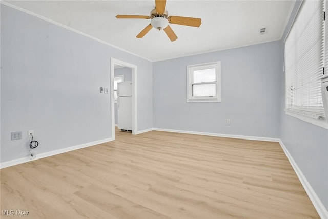 empty room featuring crown molding, ceiling fan, and light hardwood / wood-style floors