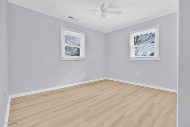 empty room with ceiling fan, ornamental molding, light hardwood / wood-style floors, and a textured ceiling