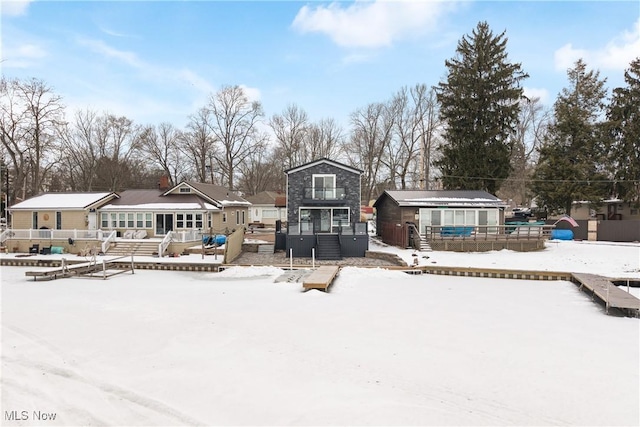 view of snow covered rear of property