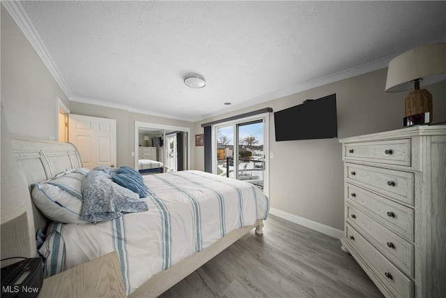 bedroom with crown molding, a textured ceiling, access to exterior, and light wood-type flooring