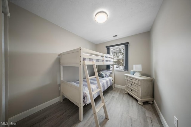 bedroom with wood-type flooring