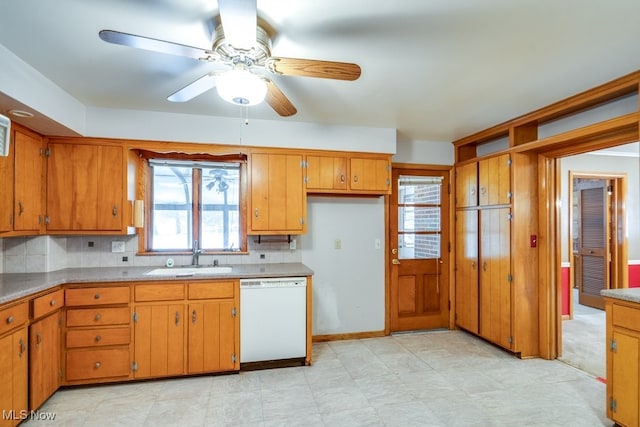 kitchen with tasteful backsplash, sink, dishwasher, and ceiling fan