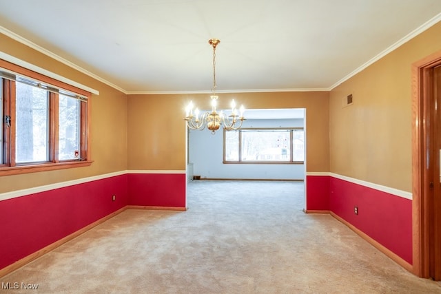 unfurnished room featuring an inviting chandelier, light colored carpet, and ornamental molding