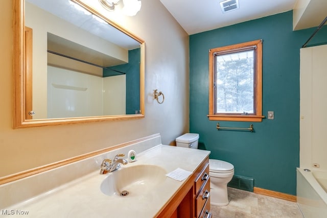 bathroom with vanity, toilet, and walk in shower