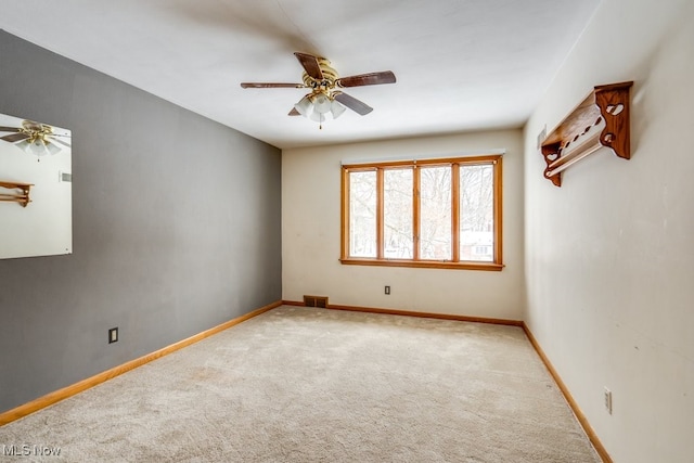 carpeted empty room with ceiling fan