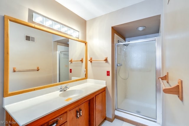 bathroom featuring vanity and a shower with door