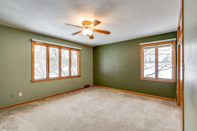 carpeted empty room with ceiling fan