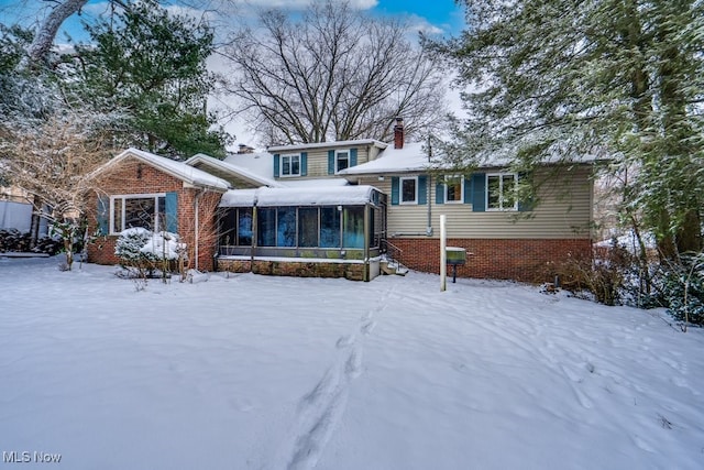 view of front of house featuring a sunroom