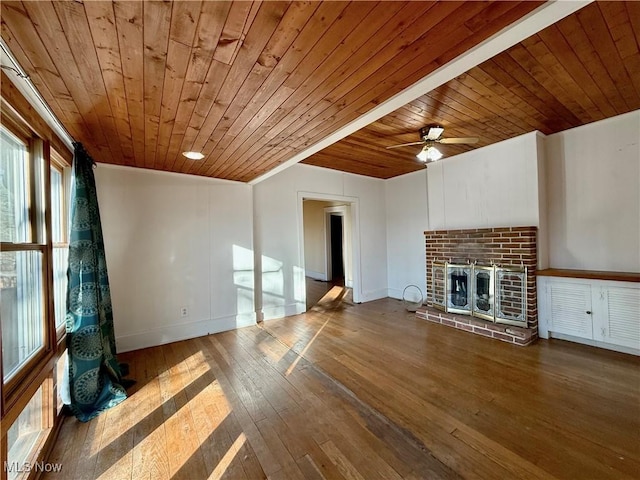 unfurnished living room featuring wood ceiling, ceiling fan, hardwood / wood-style floors, and a brick fireplace