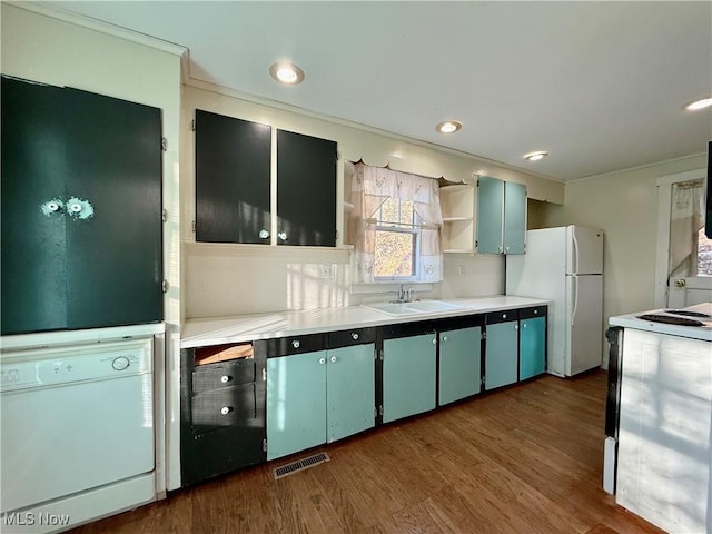 kitchen with dark hardwood / wood-style flooring, sink, and white appliances