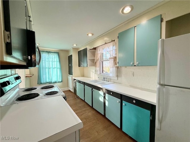 kitchen featuring range with electric stovetop, dark hardwood / wood-style floors, tasteful backsplash, sink, and white fridge