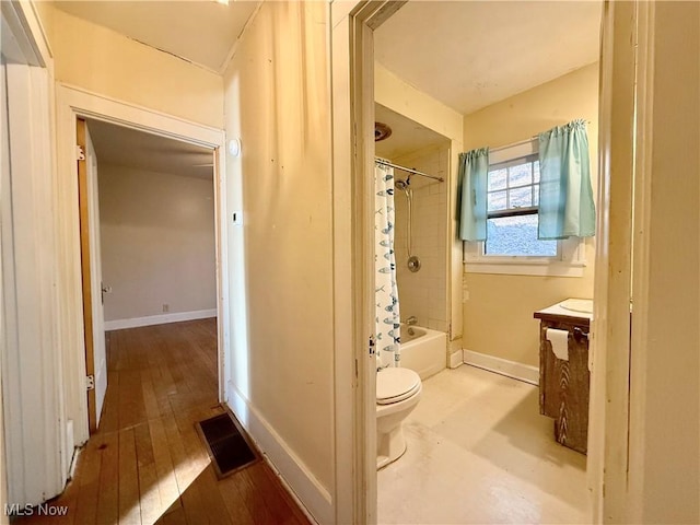 full bathroom featuring vanity, wood-type flooring, toilet, and shower / bath combo with shower curtain