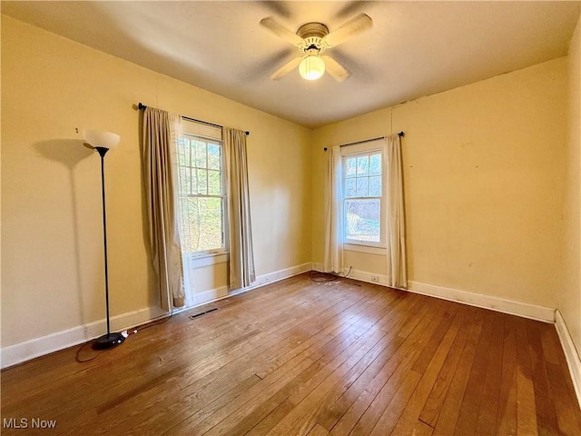 empty room featuring ceiling fan and wood-type flooring