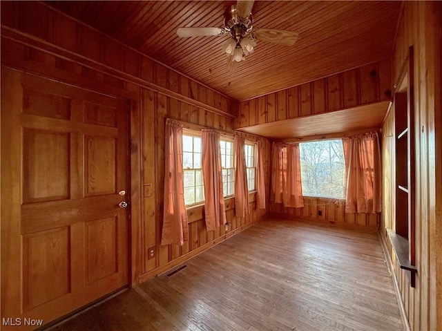 unfurnished sunroom featuring ceiling fan and wood ceiling